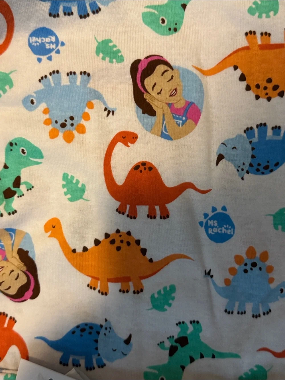 Ms Rachel Kids White Pajama Set with Blue, Orange, Green, and Purple Dinosaurs